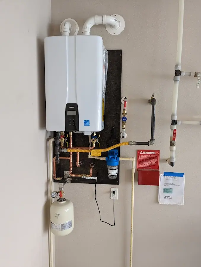 Professional plumber installing copper piping in a Suwanee home